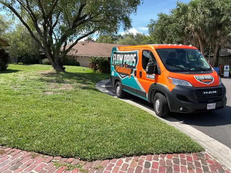 Flow Pros Plumbing van parked at a home in the Tampa Bay area with Florida license CFC-1433820 on the door